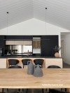 Open plan kitchen, kitchen featuring black, white and timber