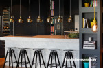 apartment, kitchen, benchtop, hanging lights, gold lighting, dark grey paint, barstools 