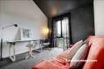 study nook, lounge, black and white study, black and white office, black feature wall, orange