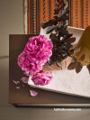 rattan accessories, rattan basket, orange rug, pink flowers, painted cases, pink vase