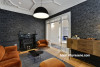 lounge, living room, wallpaper feature wall, grey wallpaper, grey and orange, grey lounge