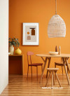 dining room, orange dining room, orange feature wall, 70s inspiration, rattan pendant