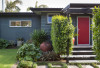 grey exterior, red front door, grey house, grey weatherboards, garden, entranceway 