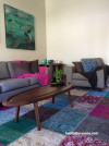 living room, lounge, neutrals, colourful accessories, colourful rug 